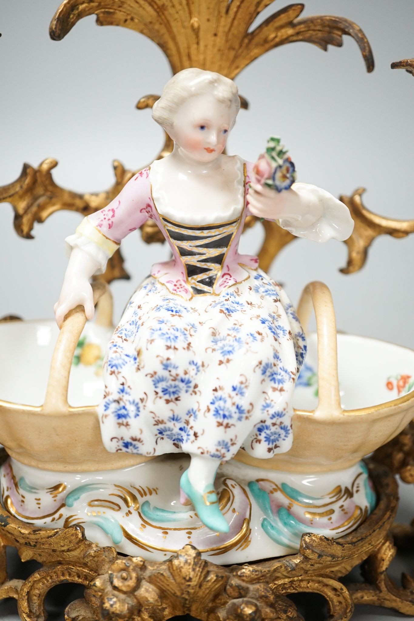 A 19th century Meissen figural salt, incised number 3024, on ormolu candle stand. Total height - 21cm